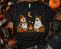 Camping Ghosts Halloween Graphic T-Shirt | Cute Campfire Ghost Softstyle Tee | Spooky Fall Adult Shirt | Cozy Autumn Apparel